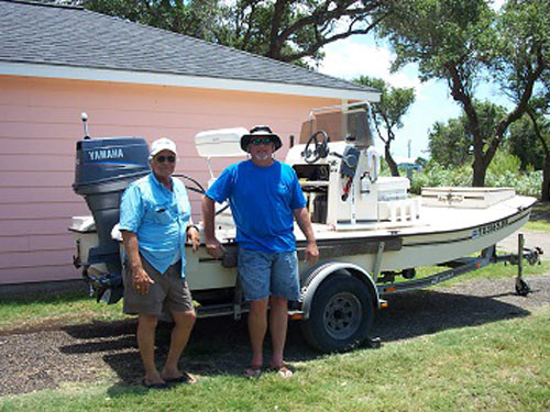 Guests with their boat parked at their site at Drifters RV Resort